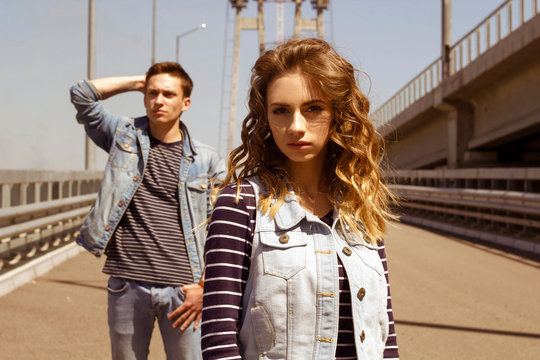 Two young people man and woman wearing jeans outdoors. Fashion concept with beautiful couple.