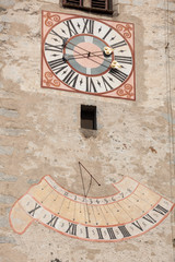 Fototapeta na wymiar The clock painted and recently restored outside the bell tower of the church.