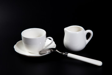 Hands adding sugar to tea cup on black background. Close up of woman's hands adding glucose syrup in coffee cup or tea for Consume less sugar. Reduce sugar consumption concept