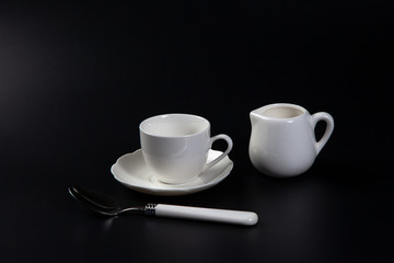 Hands adding sugar to tea cup on black background. Close up of woman's hands adding glucose syrup in coffee cup or tea for Consume less sugar. Reduce sugar consumption concept