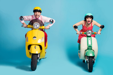 Portrait of his he her she nice attractive cheerful glad ecstatic crazy overjoyed couple riding moped having fun fast speed isolated on bright vivid shine vibrant blue color background
