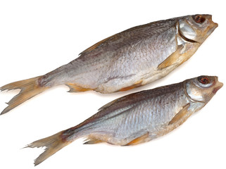 Two dried salted roach fish on a white background