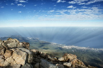 View from the top of a volcano Teide to the island of Tenerife. Cloud shadows are visible on the ground.