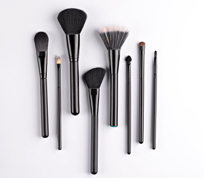 set of makeup brushes of various shapes and sizes, isolated on a white background