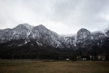 Winter mountains panorama with ski slopes. Drone flight through dramatic, snowy winter mountain range. Aerial landscape of the Alps in Europe during winter season with fresh snow. Austria.