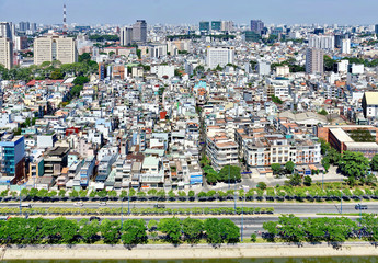 Obraz premium Cityscape of Ho Chi Minh City. Vietnamese architecture in high density residential areas. Houses are very close to each other. Top view on a bright sunny day