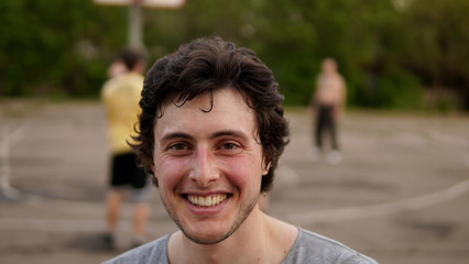 A young man posing at the basketball court