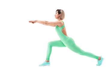 Fototapeta premium full body portrait of young sporty woman stretching before exercise isolated on white background.