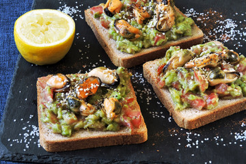 Healthy toasts with avocado pasta and mussels. Proper nutrition. Healthy breakfast or snack.