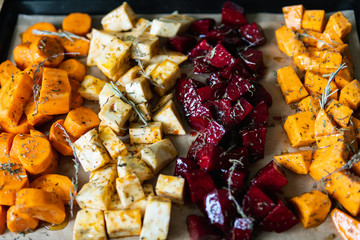 Top down view over flat lay oven tray with vegetables mix.