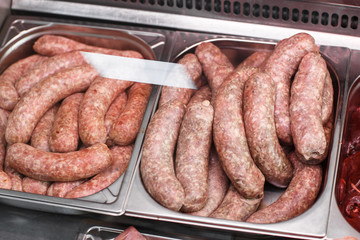 Heap of fresh meat food meat food background in supermarket store. Different types of raw meat in plastic boxes, leg of lamb on the bone, beef tail, beef neck, beef blade. Concept of farm and raw
