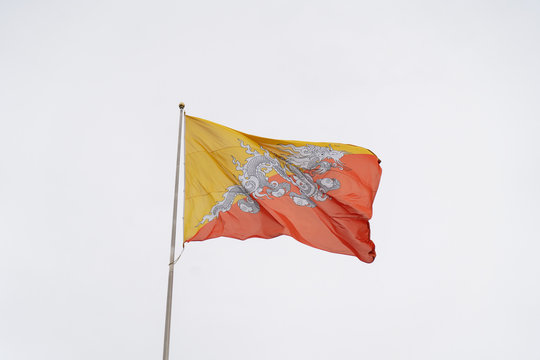 Bhutan Flag on the Cloudy Sky