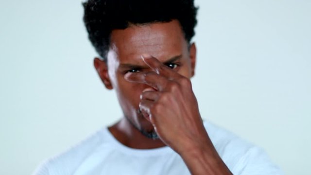 Tough looking serious African man posing to camera rejecting with finger portrait