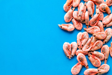 Prawn background on blue table top view frame copy space