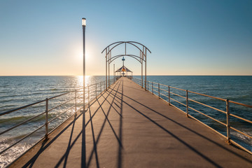 Iconic Brighton Jetty at sunset time with blue sky, South Australia