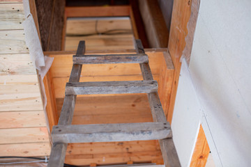 wooden staircase upstairs in a building under construction