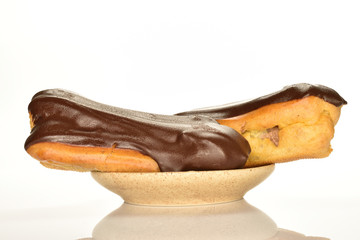 Sweet, mouth-watering chocolate eclairs, close-up, on a white background.