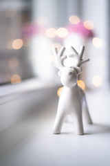 Christmas winter reindeer figure with bokeh lights in the background 