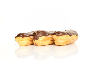 Sweet, mouth-watering chocolate eclairs, close-up, on a white background.