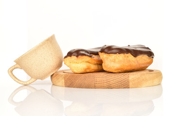 Sweet, mouth-watering chocolate eclairs, close-up, on a white background.