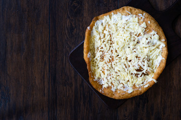Traditional Langos / Langosh are originally Hungarian fried pancakes made from yeast dough, topped with Parmesan cheese and Mild Cream Cheese / Pisi.