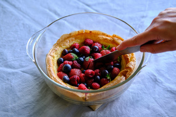 Dutch baby pancake with fresh strawberries, blueberries and raspberries