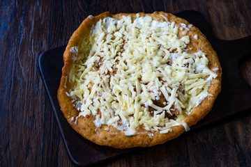 Traditional Langos / Langosh are originally Hungarian fried pancakes made from yeast dough, topped with Parmesan cheese and Mild Cream Cheese / Pisi.