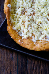 Traditional Langos / Langosh are originally Hungarian fried pancakes made from yeast dough, topped with Parmesan cheese and Mild Cream Cheese / Pisi.