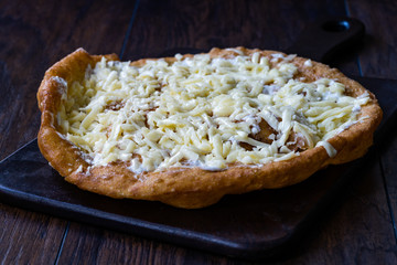 Traditional Langos / Langosh are originally Hungarian fried pancakes made from yeast dough, topped with Parmesan cheese and Mild Cream Cheese / Pisi.