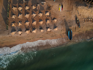 Aerial view of amazing beach with umbrellas and turquoise sea at sunrise. Black Sea at Vama Veche, Romania