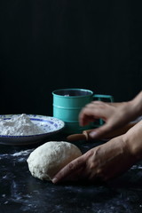 Dough ,making dough with flour on a black background, bread and pizza dough