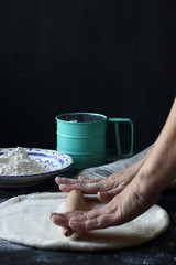 Dough ,making dough with flour on a black background, bread and pizza dough
