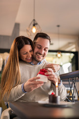 Girlfriend giving boyfriend birthday present