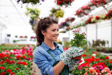 Woman in nursery plant working with flowers