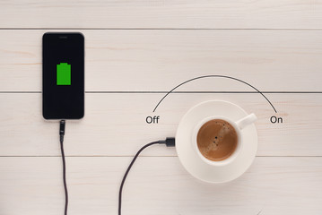 a cup of coffee transfers energy via cable to a mobile phone