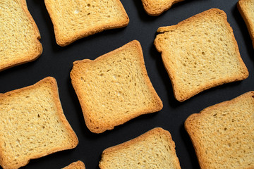 Bread toasts on a black tray, Flat lay, top view.