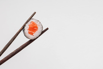 Sushi on black wooden sticks on a white background