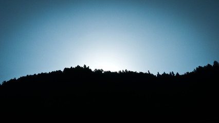 Close up of sunlight from mountain behind