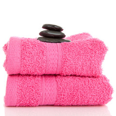 Fototapeta na wymiar Two pink towels with black pebbles on top