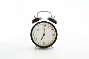 Black retro alarm clock isolated on white background. Copy space. Blank template backdrop. Early...