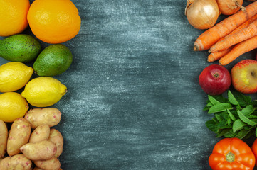 Flat lay of multi-colored raw vegetables on a black background, food frame. Local products for healthy cooking. Eco-friendly products. Clean food. Top view. Copy space.