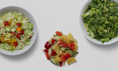 Salad pieces on plates on a white background