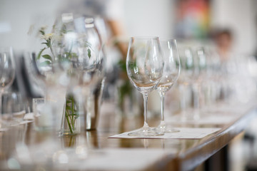 Tables setting at a luxury wedding. Table for guests. Dishes and drinks. Floral decorating, white chairs and table. Wedding table preparation. top view. Horizontal photo
