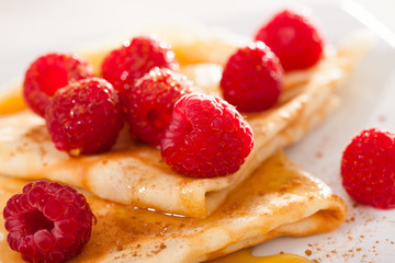 delicious  pancakes with fresh raspberries and honey