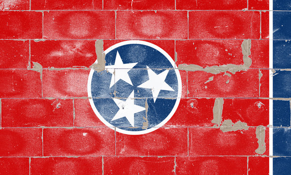 The national flag of the US state of Tennessee on a red background with a narrow blue stripe to the right. In the center is a blue circle with a white border, inside it are three white stars.