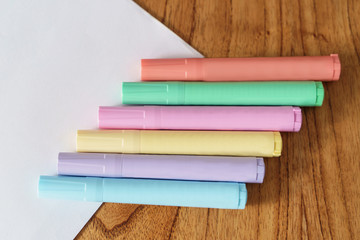 Different colored markers on a white sheet