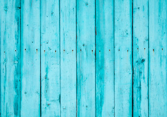 Wooden boards on an old blue fence as an abstract background.