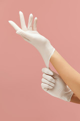Gloves. Doctor Or Nurse Putting On Hands White Surgical Protective Uniform. Professional Medical Safety And Hygiene For Infection Prevention.