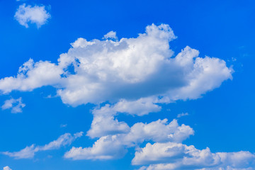 Naklejka na ściany i meble White fluffy clouds in the blue sky