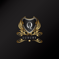 Shield logo in gold color with letter Q Logo. Elegant logo vector template made of wide silver alphabet font on shield frame ornate style.
